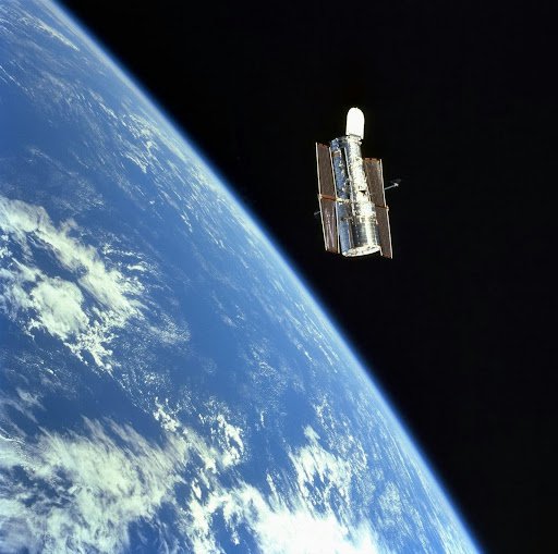 Image of a satellite in space floating above Earth