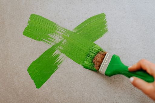 A green x painted onto a plain background
